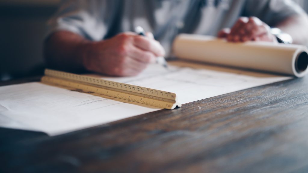 Architect at drafting table.